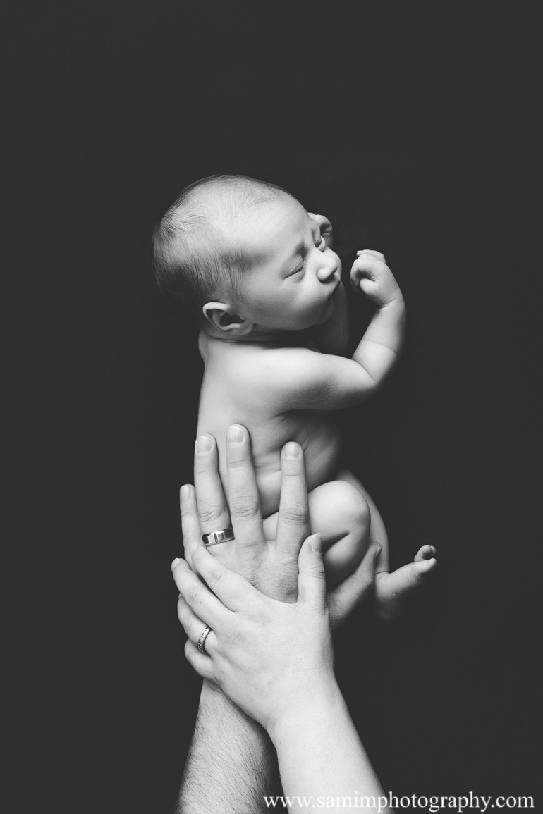 Ashburn GA newborn photographer precious studio newborn session newborn with parents hands